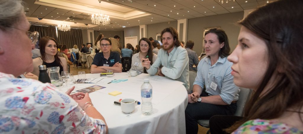 a roundtable discussion being held with attendees of the conference